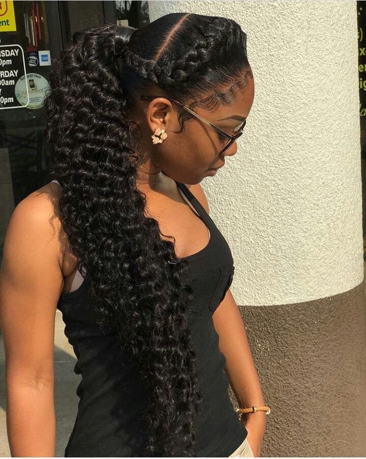 Low braided ponytail with the ends wrapped up and under and pinned out of sight