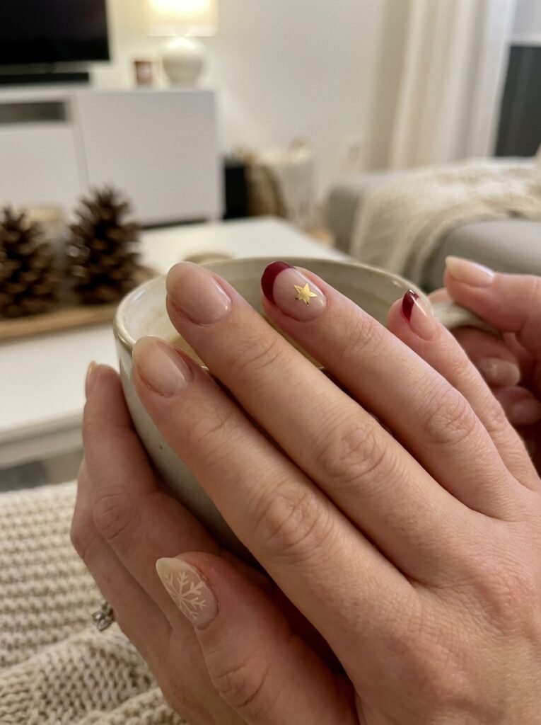 Subtle holiday nail detail featuring a delicate snowflake accent