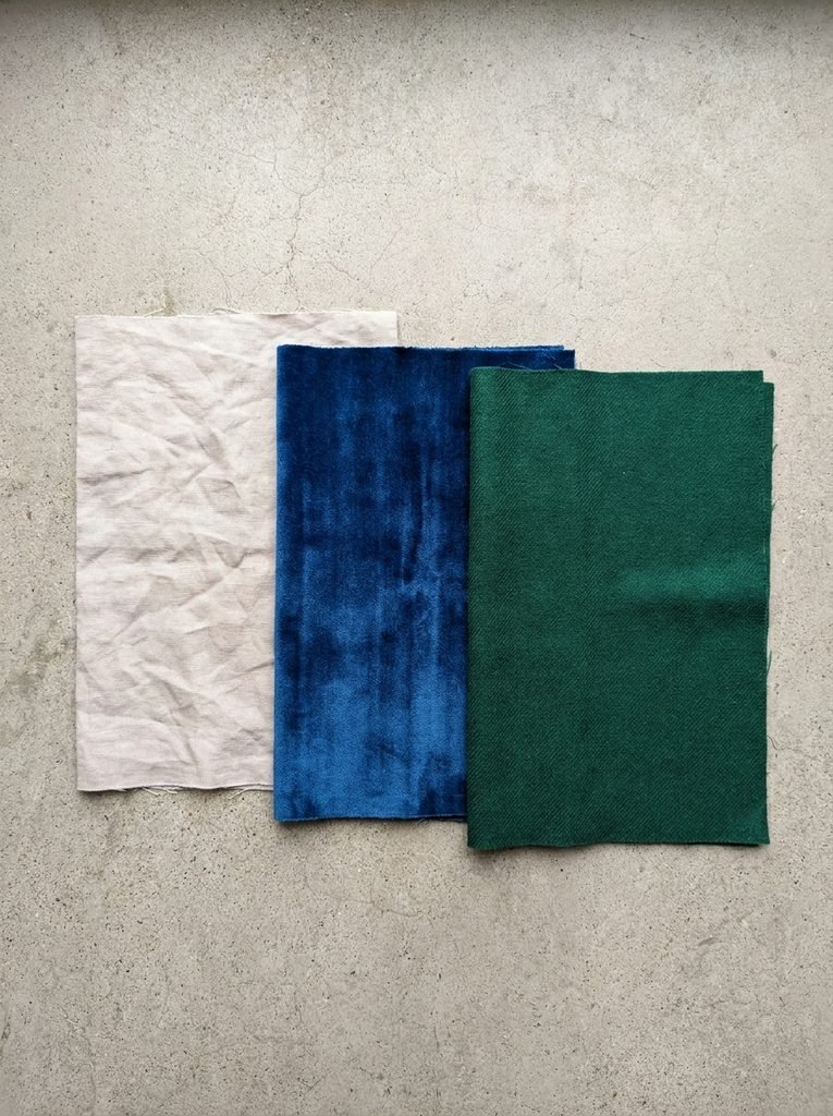 Fabric swatches comparing a washed-out beige to rich sapphire and emerald tones