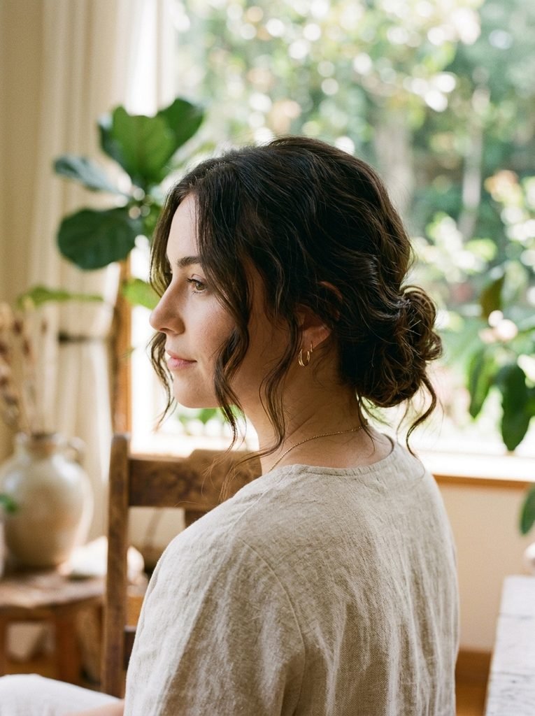 Low bun with loose face-framing pieces