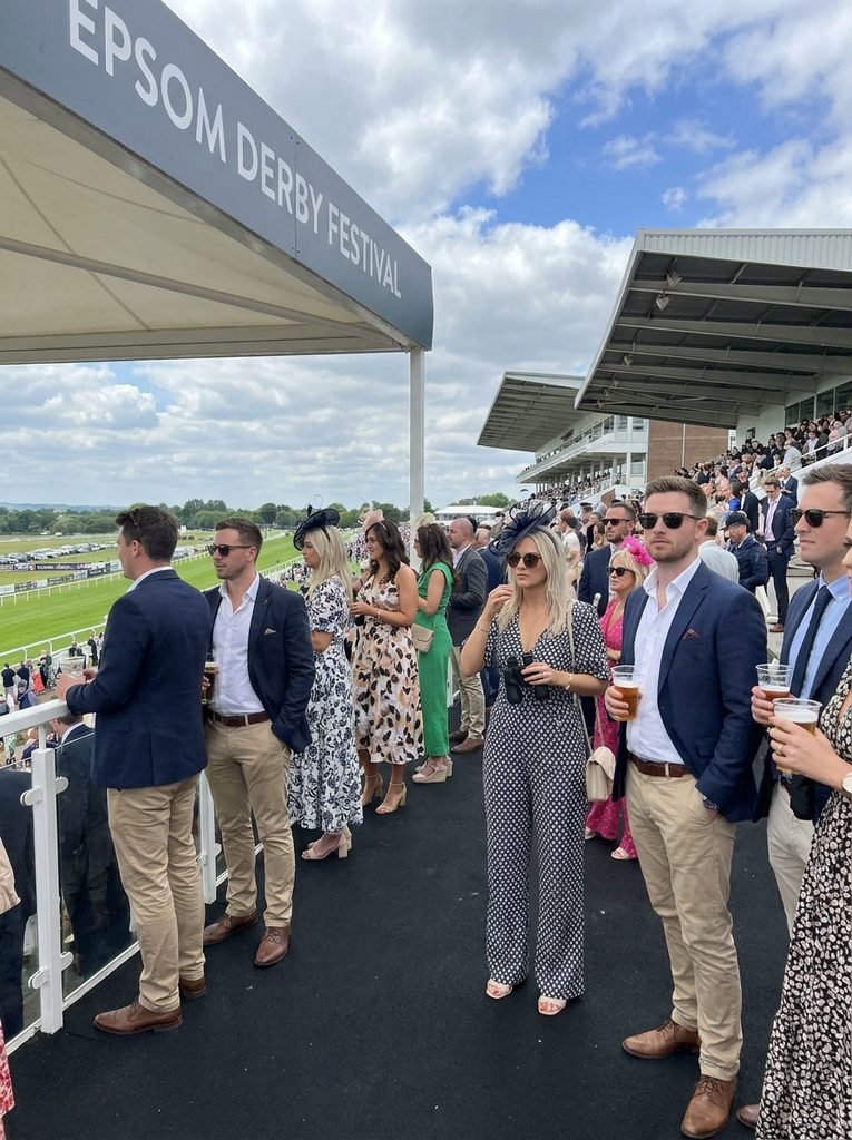 Smart-casual racegoers in the Epsom Derby Grandstand enclosure