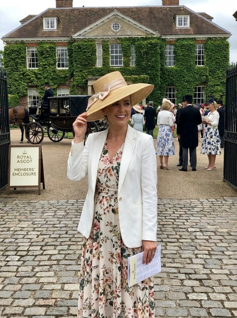 Woman adjusting a wide-brimmed hat before heading to Royal Ascot